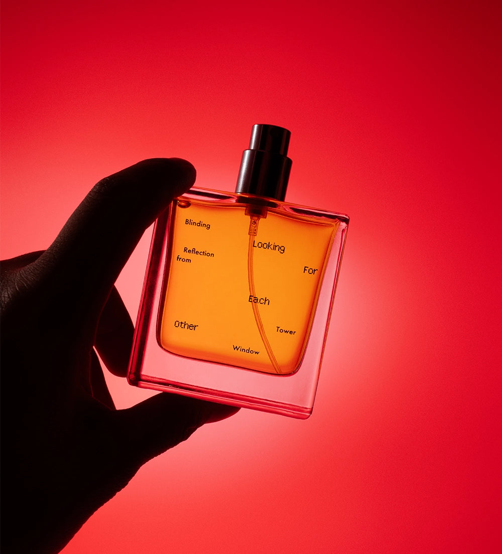 The Looking for Each Other fragrance Blinding Reflection from Tower Windowlit with dramatic red light and dark shadows, evoking emotional depth and directional scent.