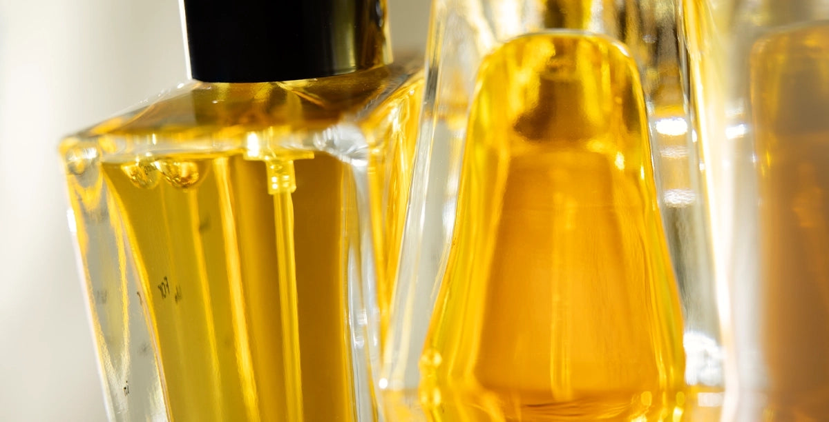 Extreme close-up of golden botanical liquid inside a Looking for Each Other perfume bottle—showing clarity, light, and purity of ingredients.